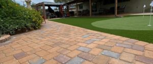 Paver patio installed next to custom putting green